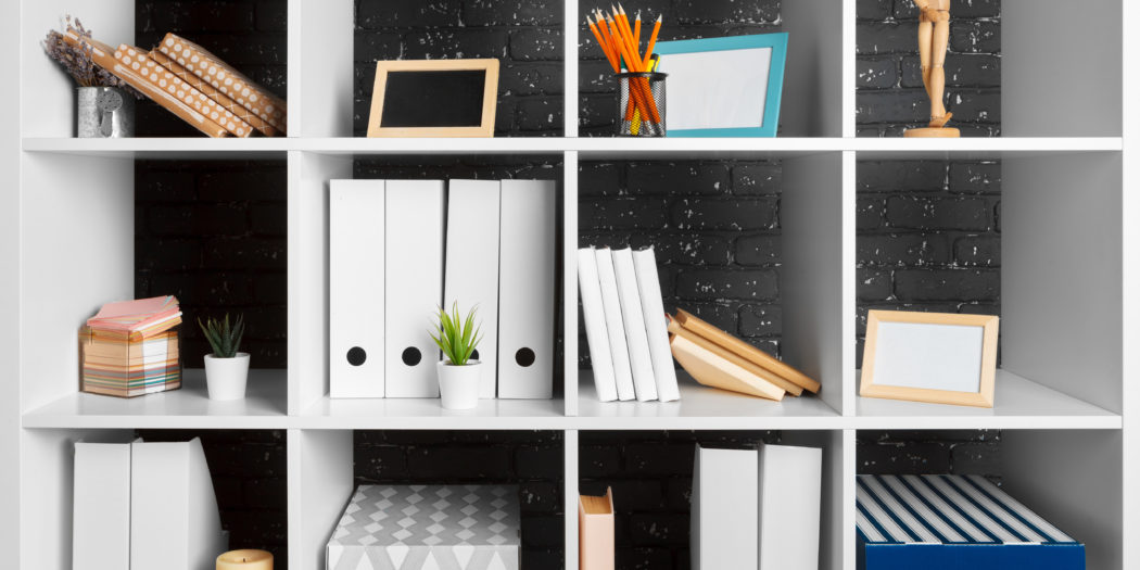 półka z dokumentami w segregatorach i w pudełkach